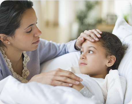 Parent checking a child in bed.