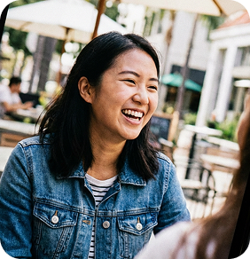 Smiling woman laughing in outdoor cafe